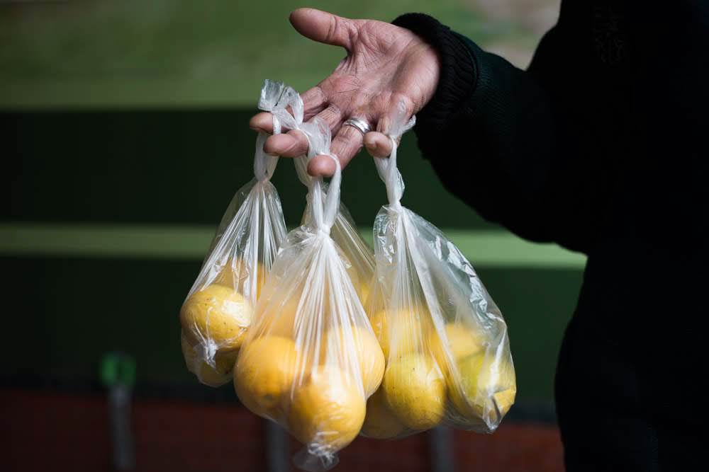 Lemon vendors complain about their hands; they have to hold bags in the air for several hours to attract customers. (Tamuna Chkareuli / OC Media)