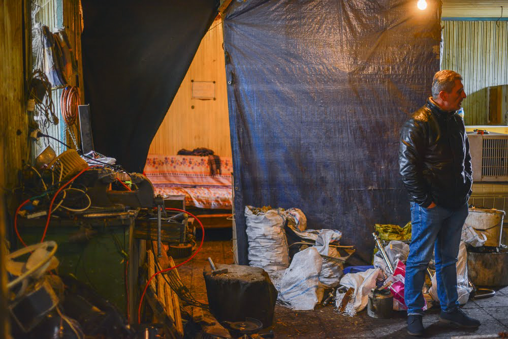 ‘The office’ behind the curtain on the shop floor is a small room with a sofa and a tin stove. (Tamuna Chkareuli/OC Media)