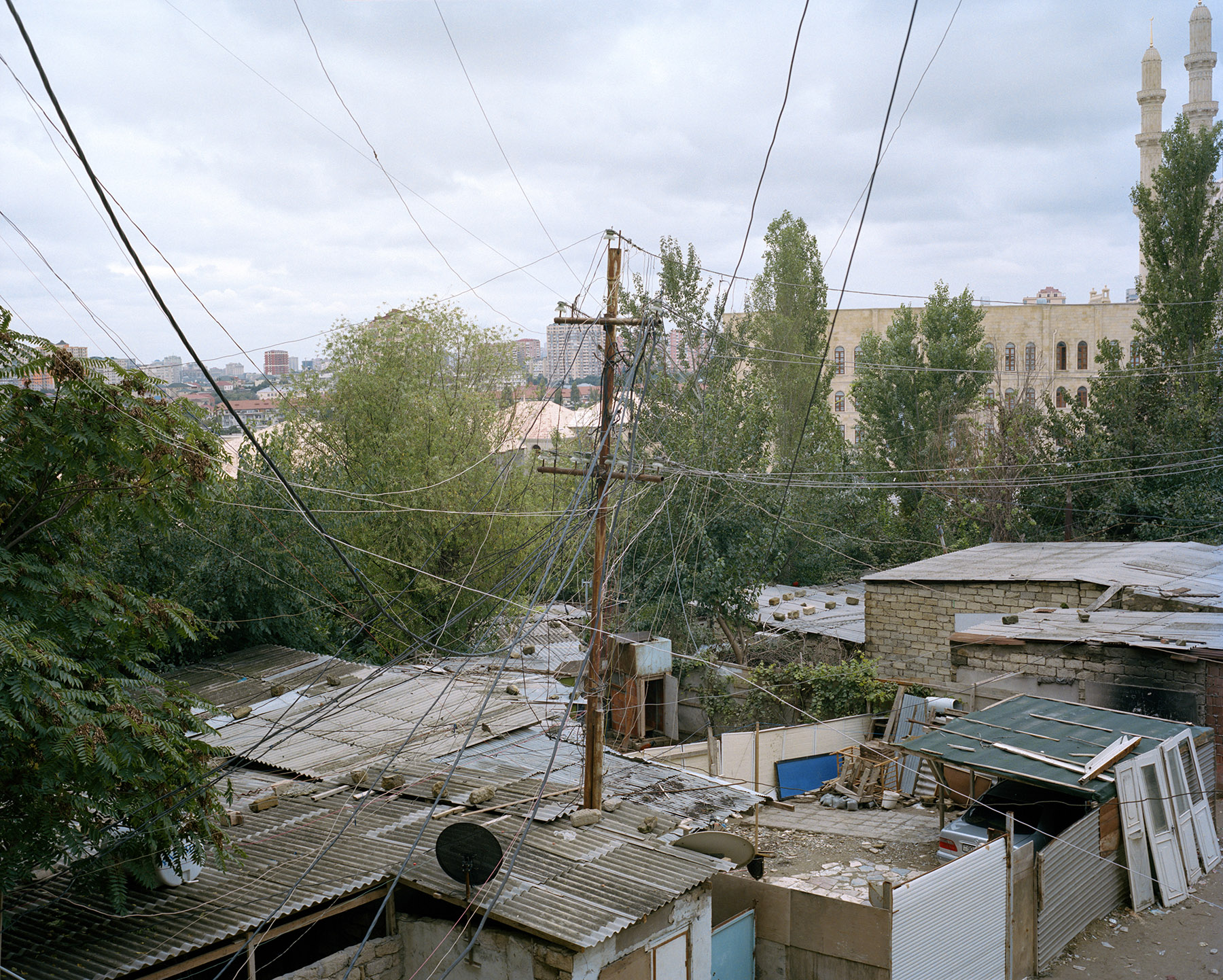 2017: The homes of internally displaced persons from Nagorno-Karabakh are illegally tapped into the city's electrical grid by a tangle of wires.

The homes are directly behind Heydar Aliyev Mosque, the largest mosque in the South Caucasus.
