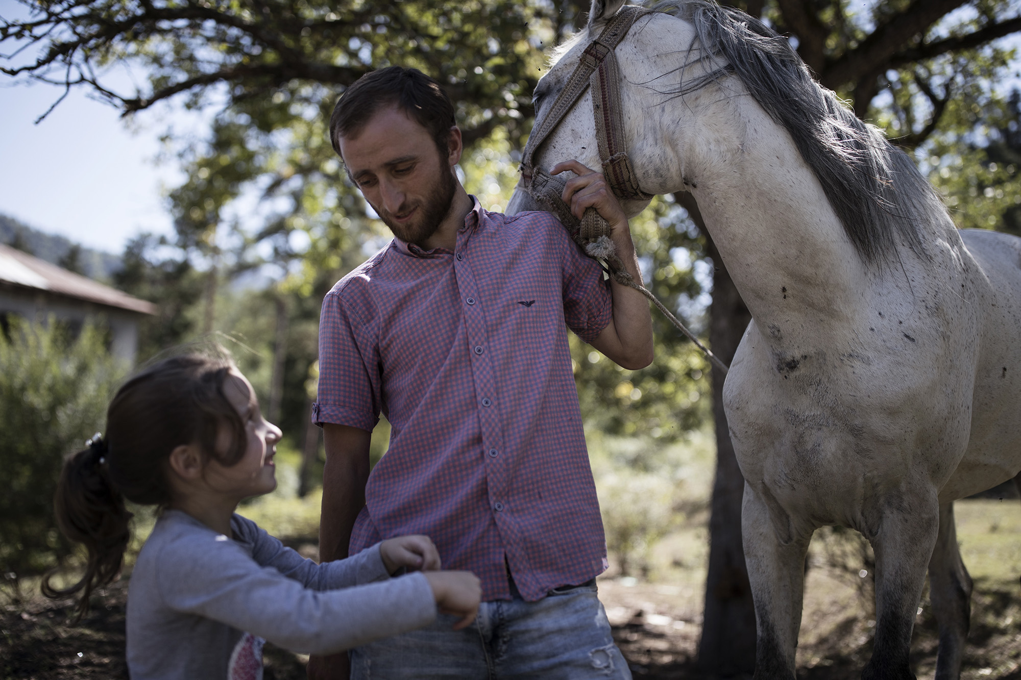 Jemal Ghonghadze with his daughter and horse in Likani. Photo: Ekaterina Anchevskaya/OC Media.